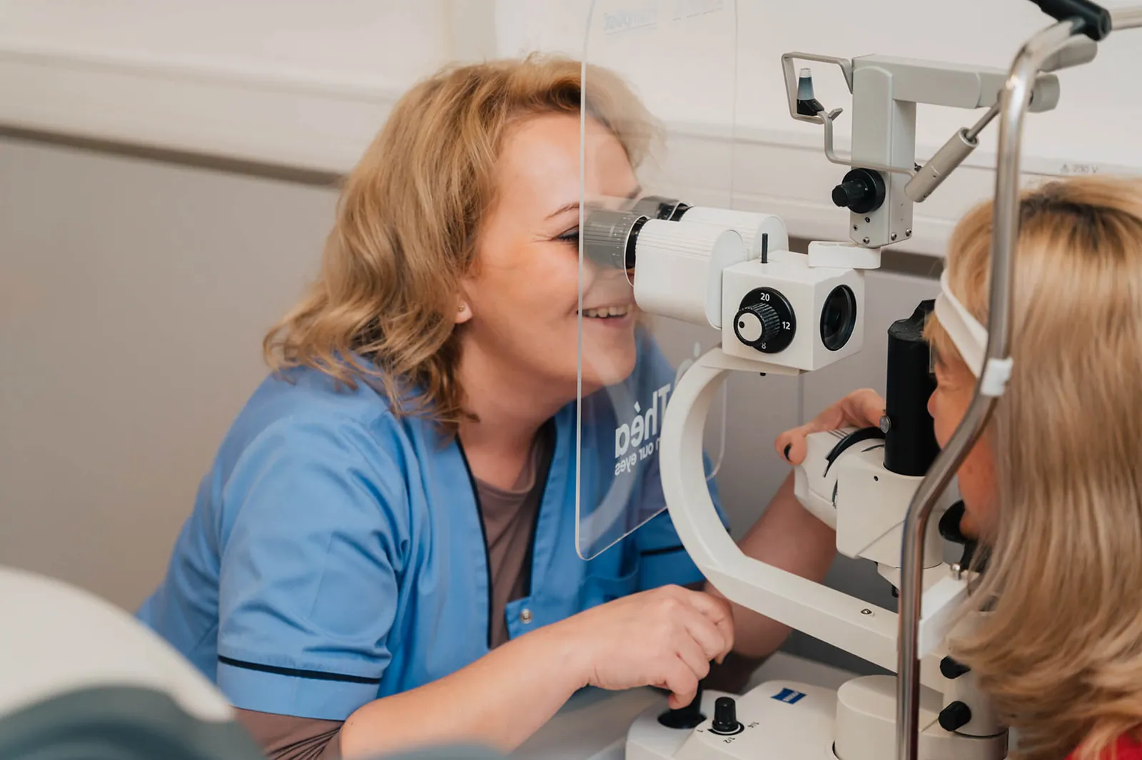 Medic oftalmolog examinând ochiul pacientului la biomicroscop pentru evaluarea cataractei
